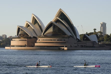 Kayakers drift past the Sydney Opera House on Sydney Harbour.