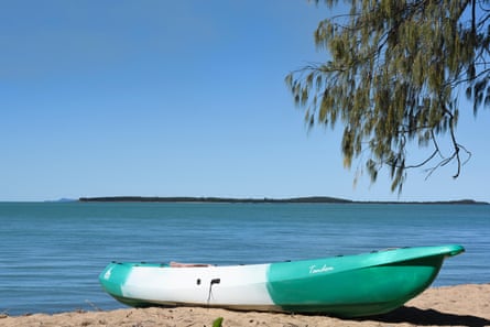 A green and white canoe on the Whitsunday coast, Queensland, Australia