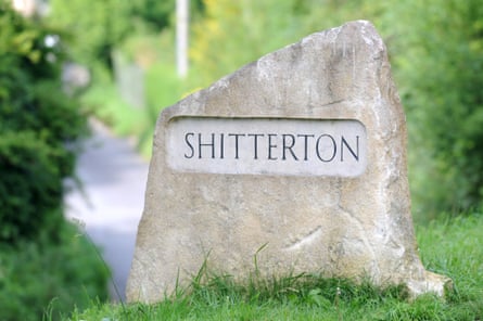 A large rock by a roadside with Shitterton carved into it