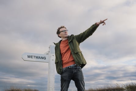 Tom Lamont standing next to a road sign for Wetwang in east Yorkshire.
